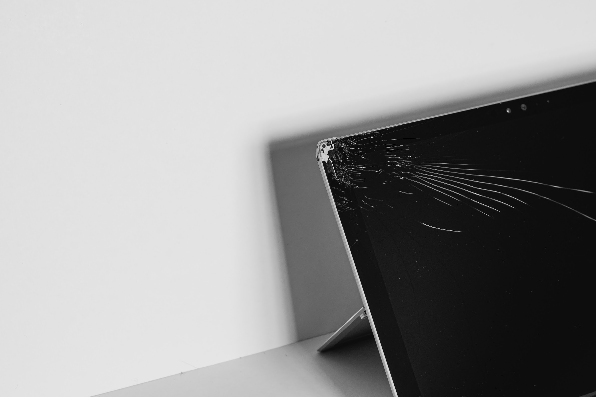 A cracked laptop screen against a white background