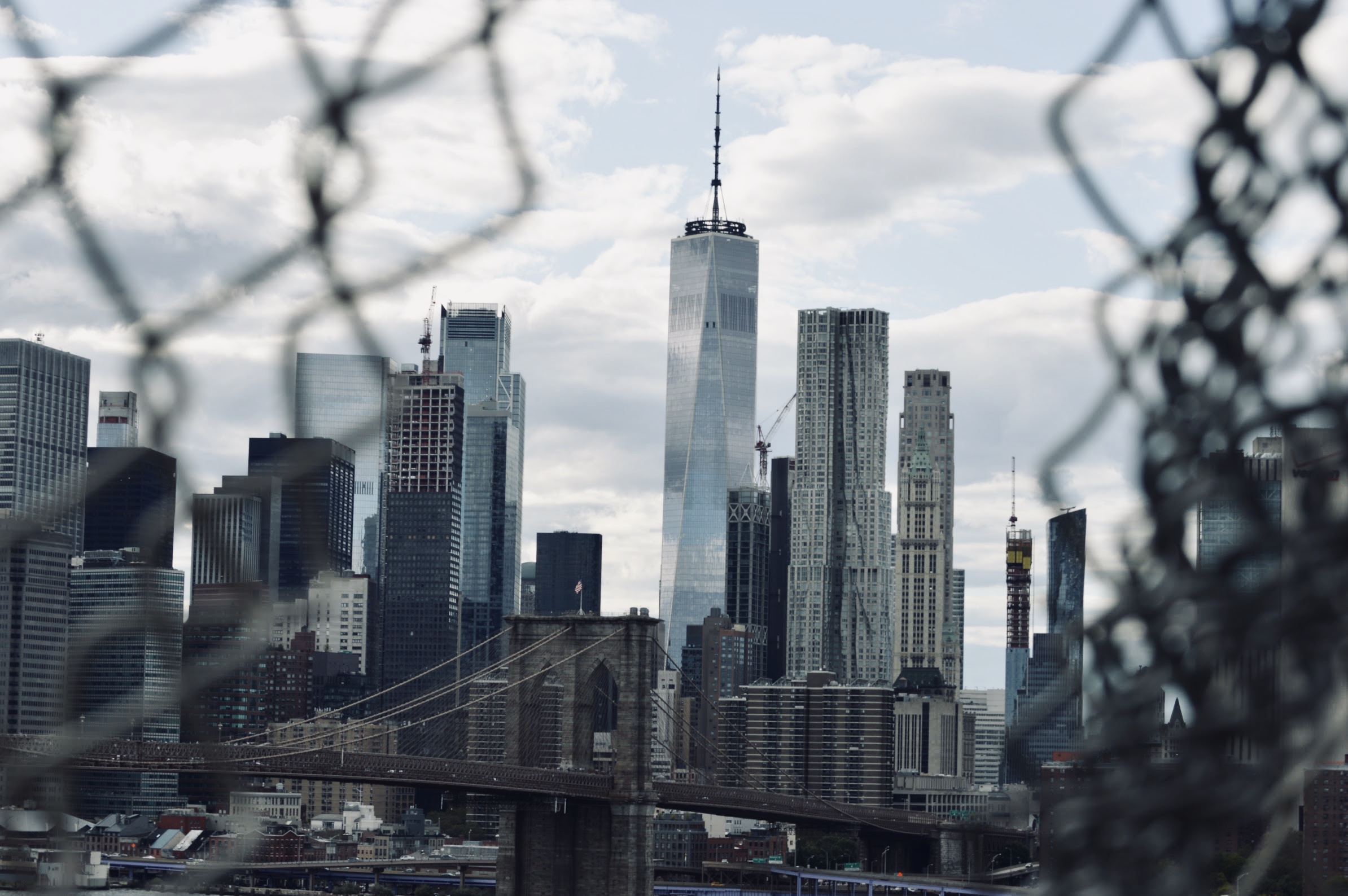 New York City skyline seen from a broken fence