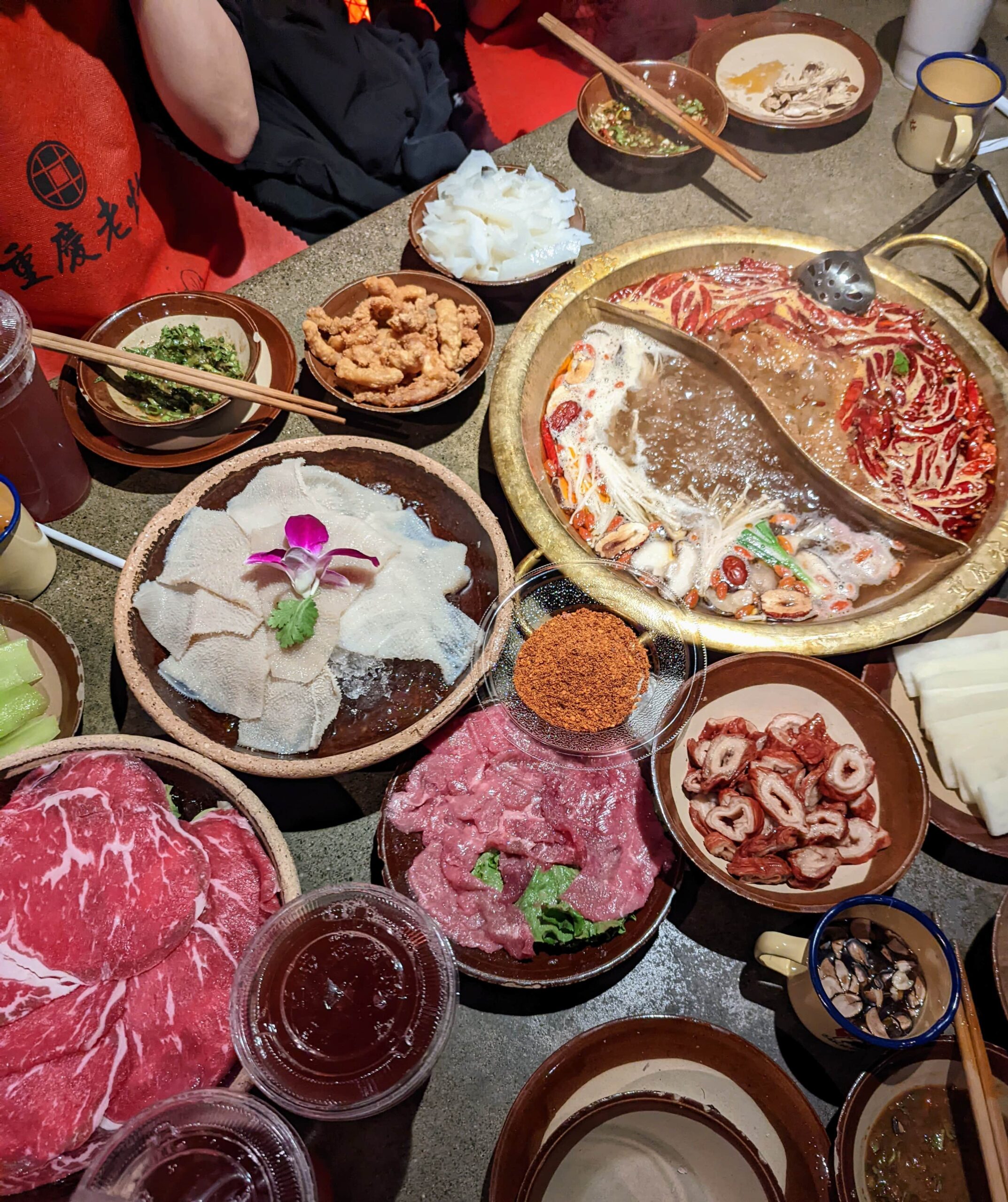 A variety of hot pot dishes on a table at Chong Qing Lao Zao.